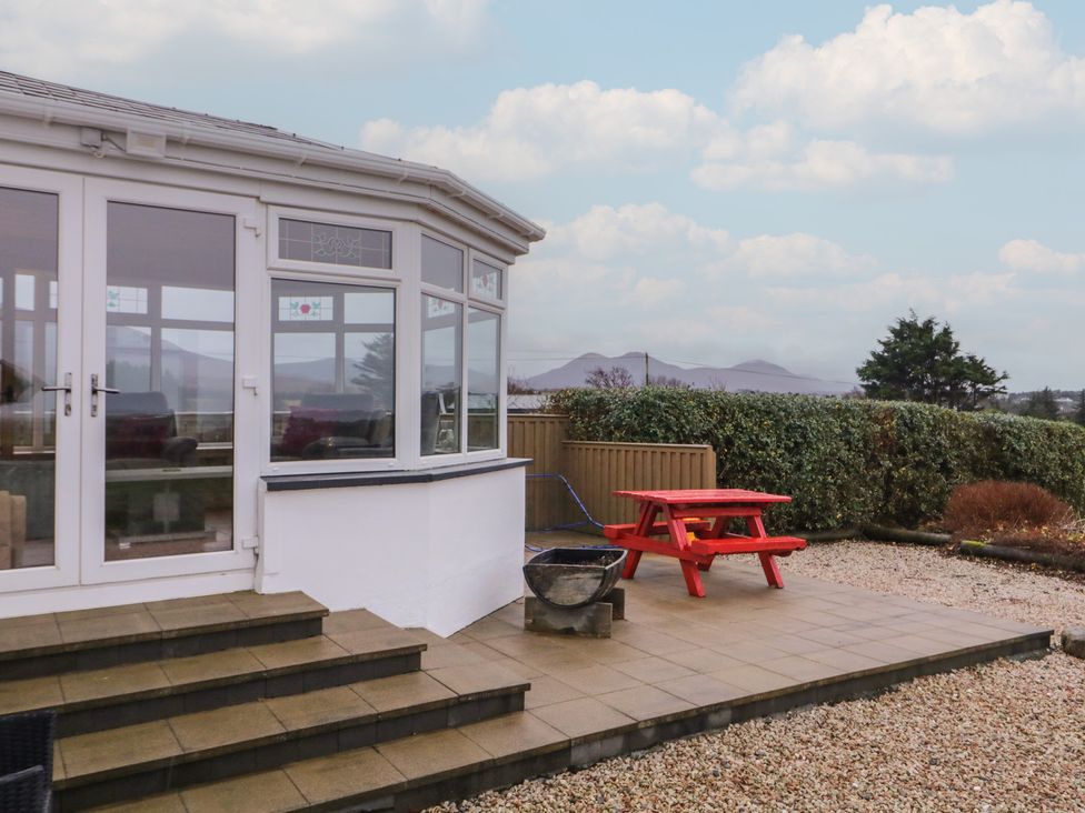 A conservatory with steps leading to a patio area at Bungalow Falcarragh in Falcarragh, County Donegal