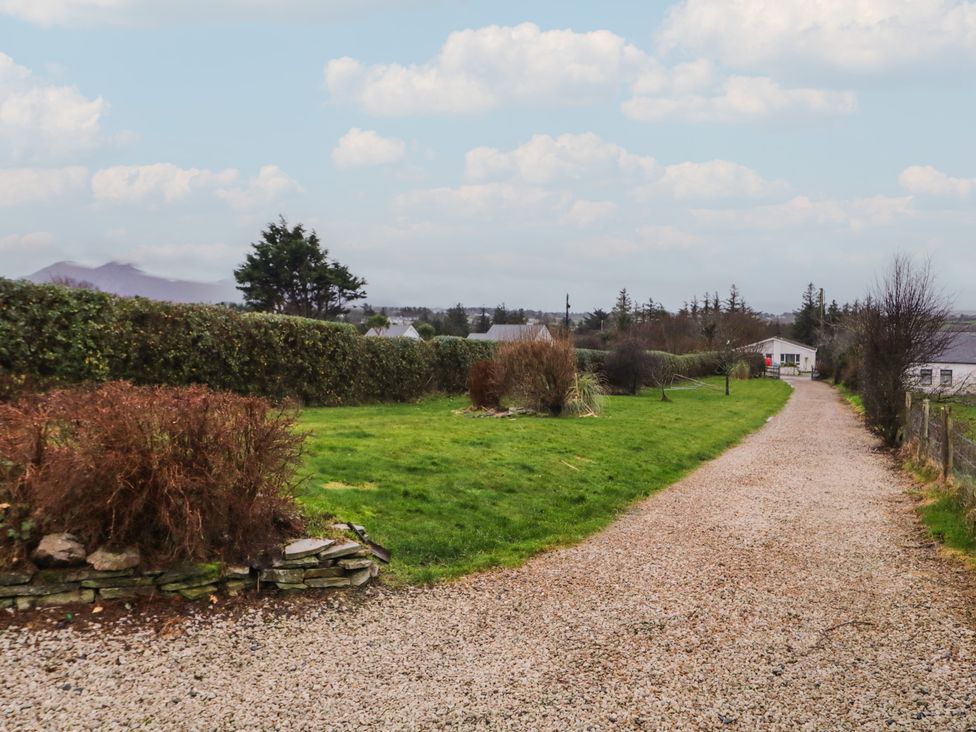 A gravel path leading to a house surrounded by grass and hedges at Bungalow Falcarragh in Falcarragh, County Donegal