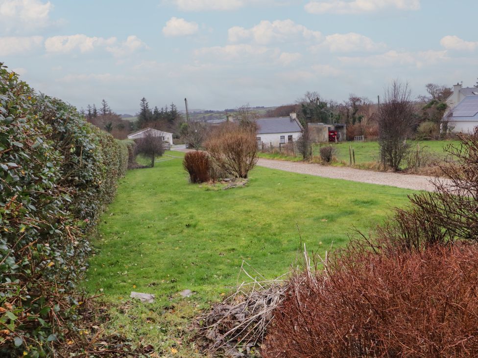 A view of a garden with hedges and buildings at Bungalow Falcarragh in Falcarragh, County Donegal