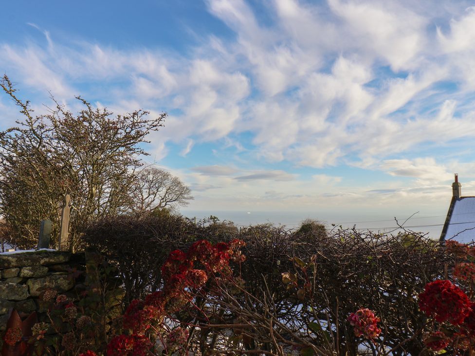 A view of clouds and bushes with flowers at Cheyne Cottage in Fylingthorpe