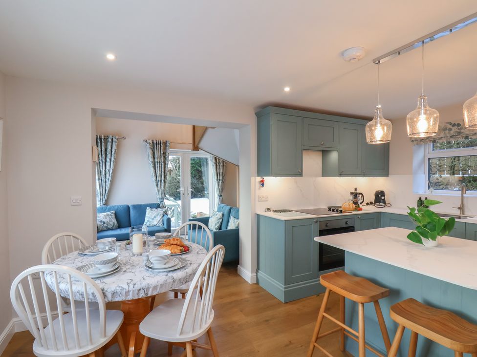 A kitchen with a table and chairs at Cheyne Cottage in Fylingthorpe
