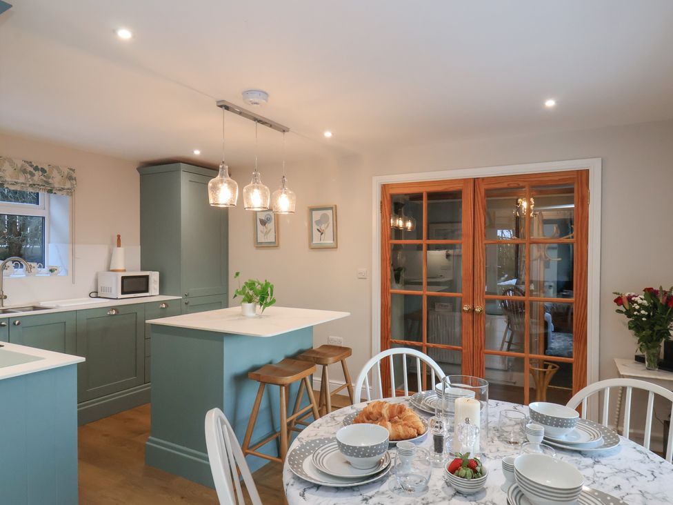 A kitchen with a dining table set at Cheyne Cottage in Fylingthorpe