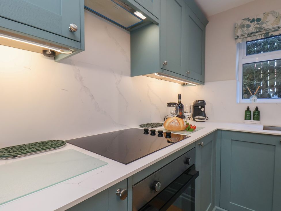 A kitchen with cabinets and countertop at Cheyne Cottage in Fylingthorpe