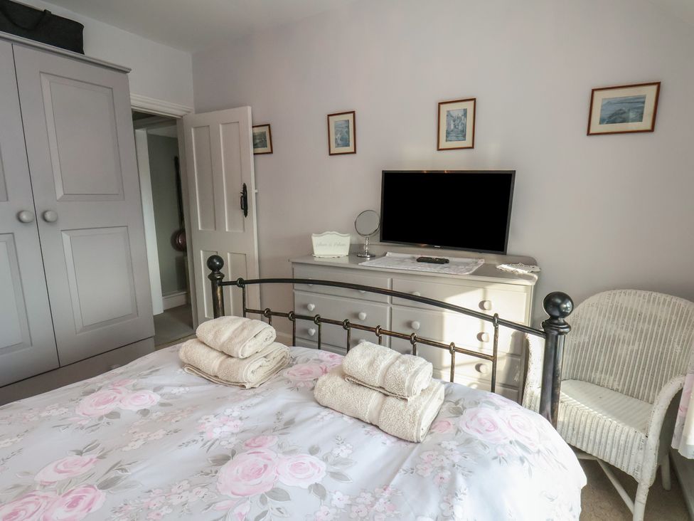 A bedroom with a bed and dresser at Cheyne Cottage in Fylingthorpe