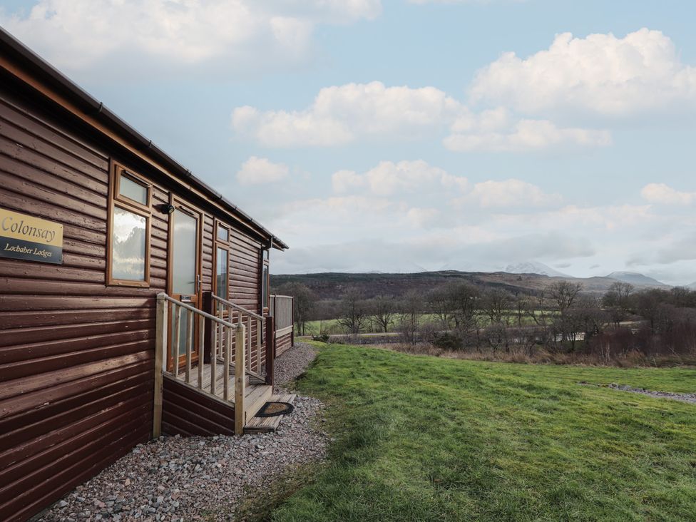 A lodge with a deck and surrounding landscape at Colonsay