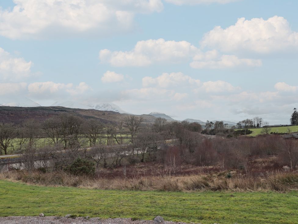 A landscape view with trees and mountains at Colonsay