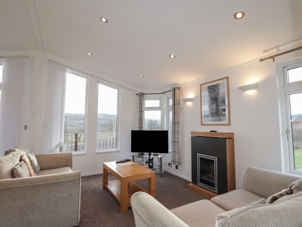 A living room with a television and fireplace at Colonsay