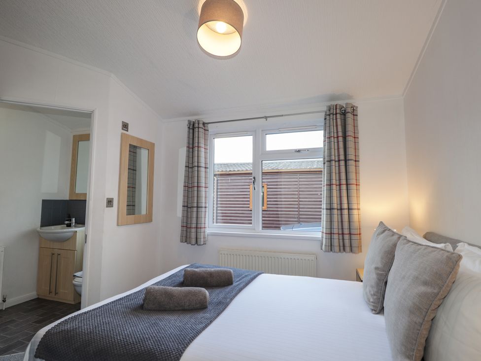 A bedroom with a bed and window at Colonsay
