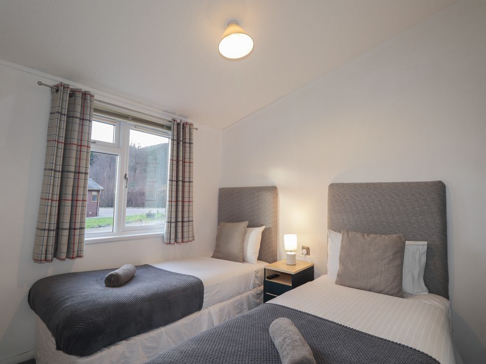 A bedroom with two beds and a window at Colonsay