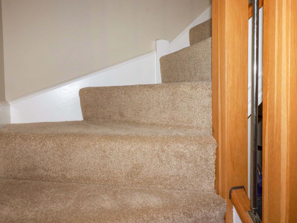 A staircase with carpet leading to a landing at 3 Rope Walk St. Austell
