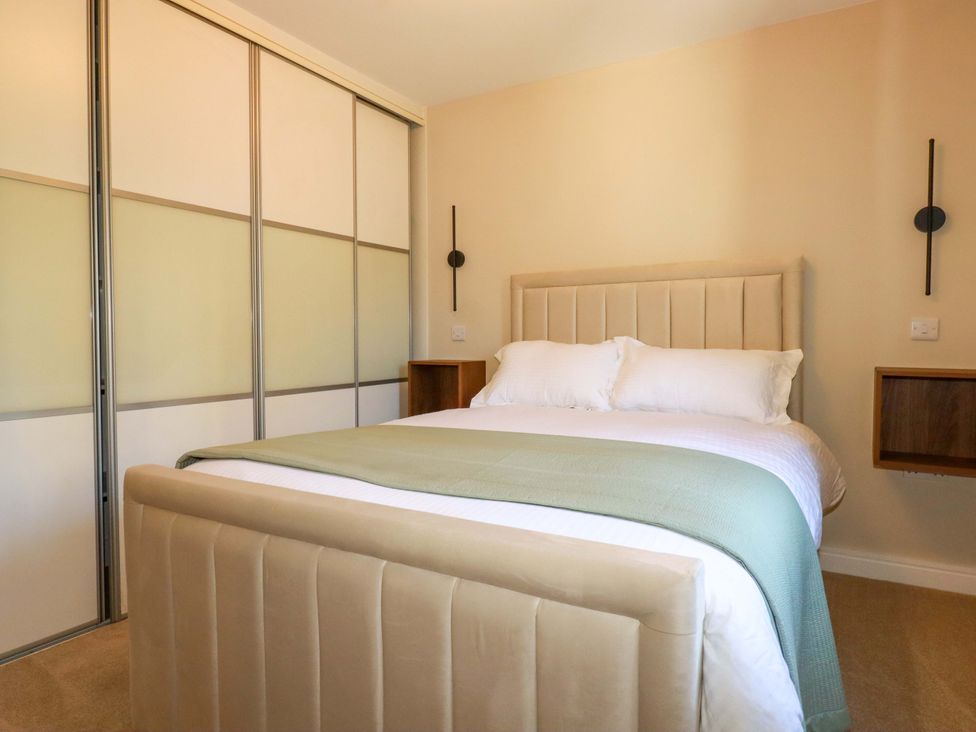 A bedroom with a bed and wardrobe at 3 Rope Walk in St. Austell