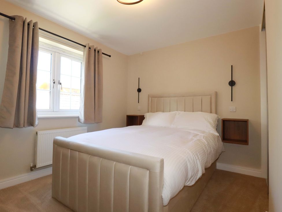 A bedroom with a bed and window at 3 Rope Walk in St. Austell
