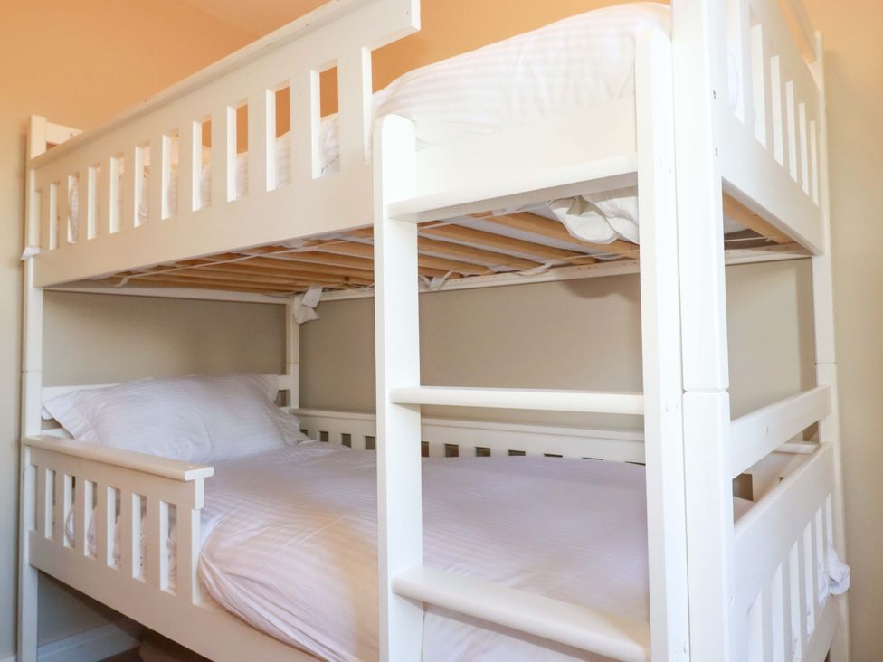 A bunk bed with mattresses and pillows at 3 Rope Walk in St. Austell