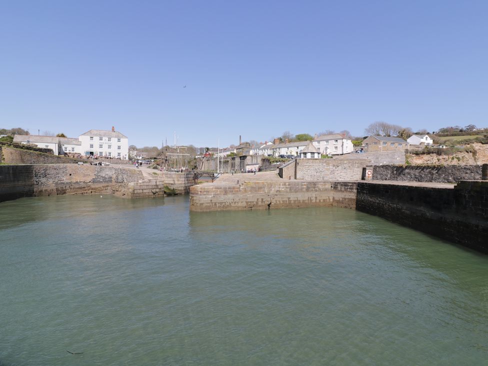 A harbor view with buildings and water at 3 Rope Walk, Duporth near Charlestown