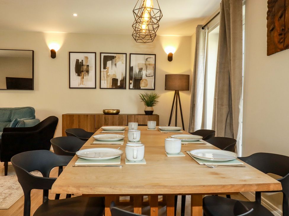 A dining room with a table set for dinner at Trelawney House in Duporth near Charlestown