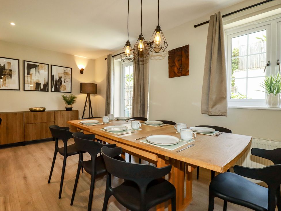 A dining room with a table and chairs at Trelawney House Duporth near Charlestown
