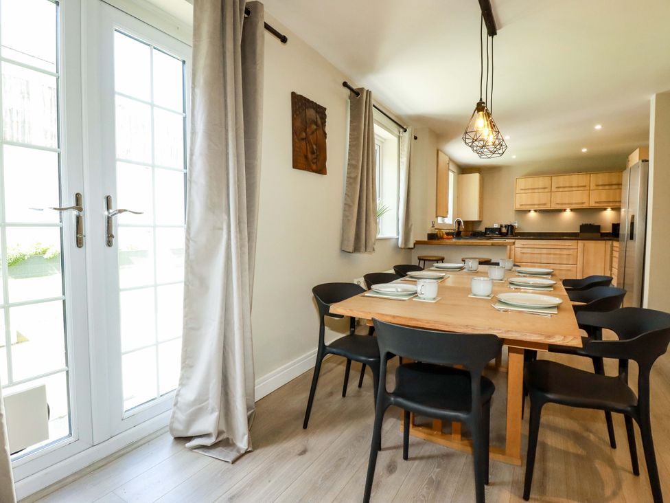 A dining room with a table and chairs at Trelawney House Duporth near Charlestown