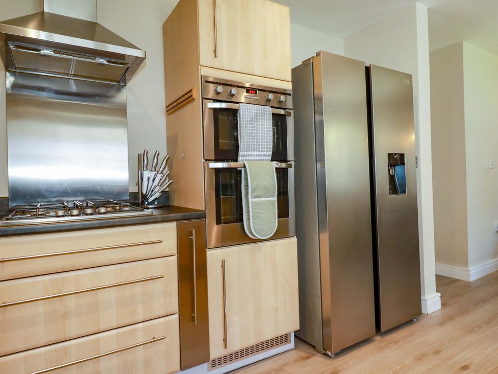 A kitchen with an oven and refrigerator at Trelawney House Duporth near Charlestown