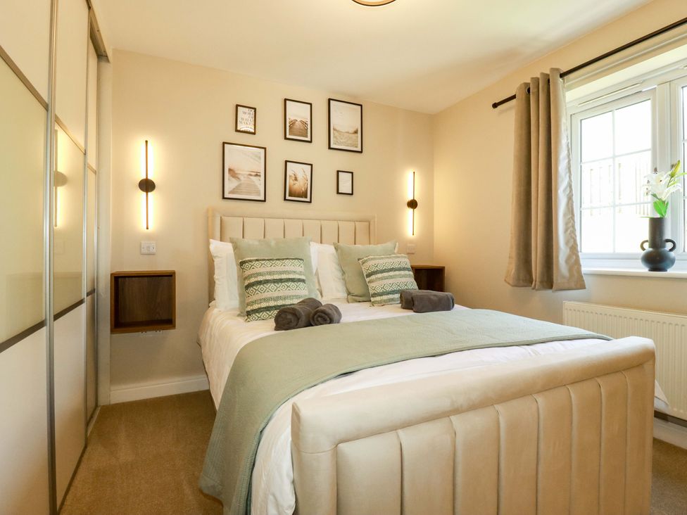 A bedroom with a bed and decorative items at Trelawney House in Duporth near Charlestown