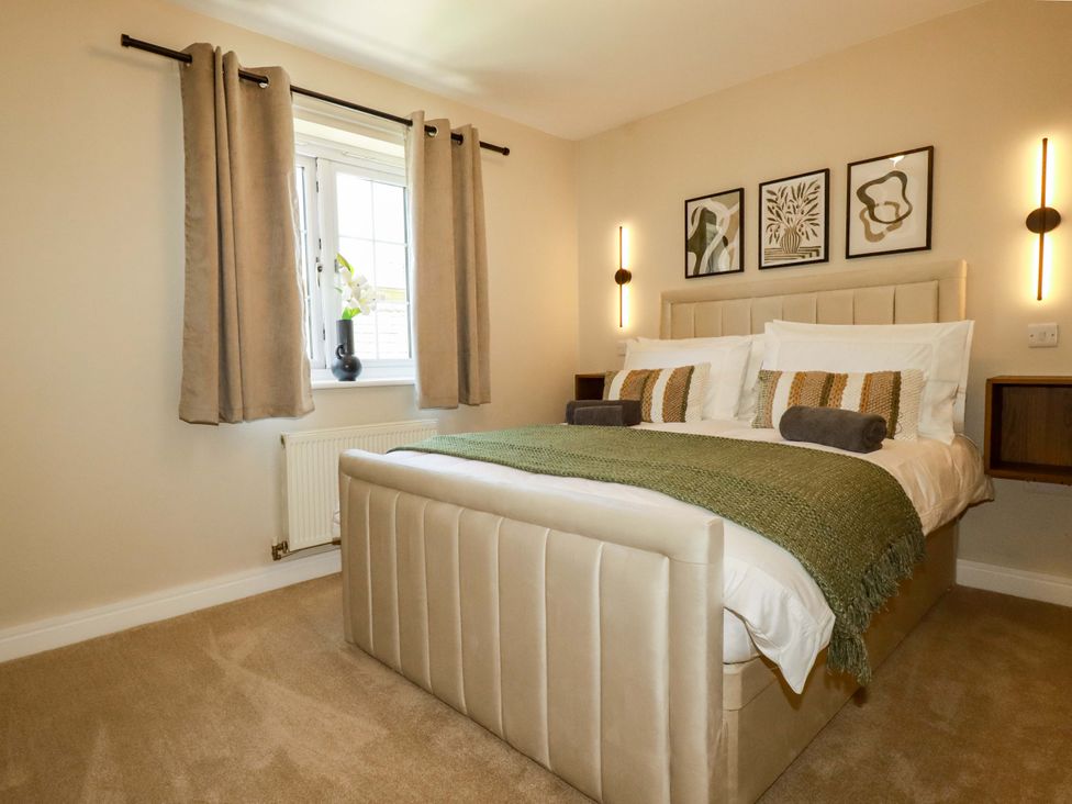 A bedroom featuring a bed and window at Trelawney House Duporth near Charlestown