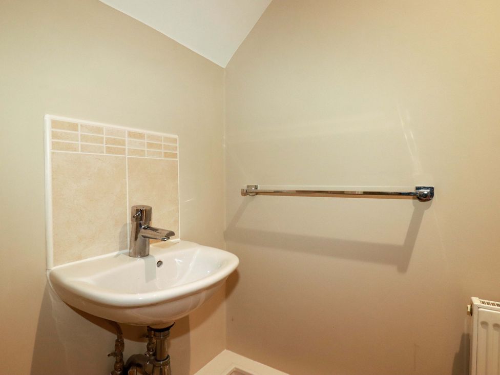 A bathroom with a sink and towel rail at Trelawney House Duporth near Charlestown