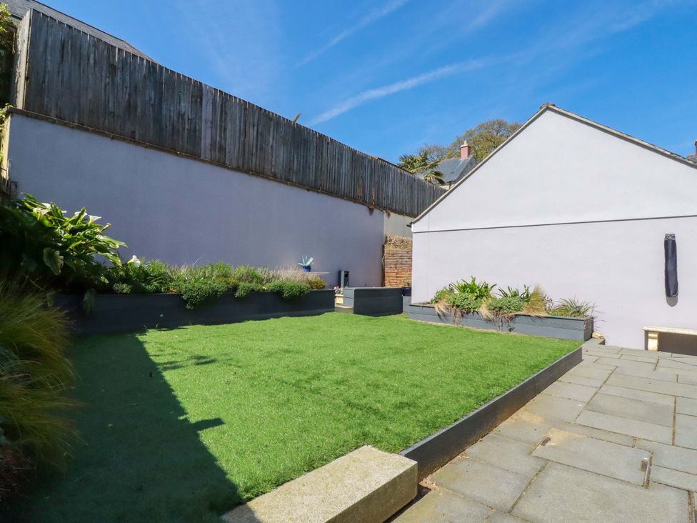A garden with grass and garden beds at Trelawney House Duporth near Charlestown