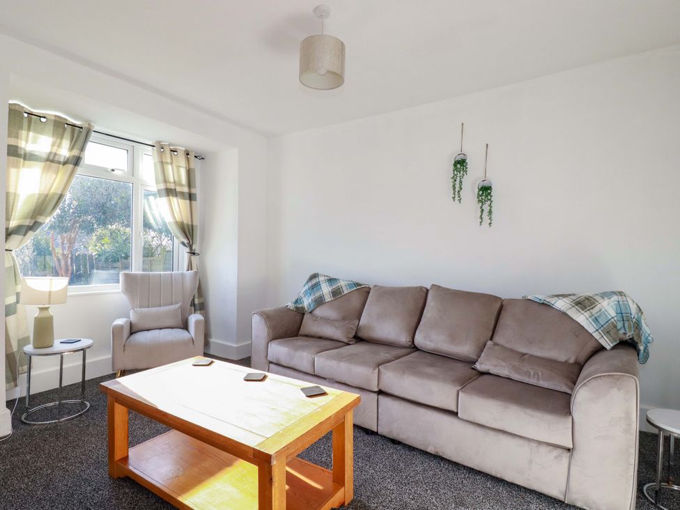 A living room with a sofa and coffee table at 39 Trevarthian road St Austell