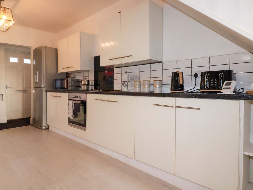 A kitchen with cabinets and appliances at 39 Trevarthian road St Austell