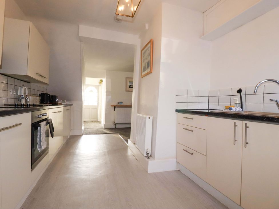 A kitchen with cabinets and appliances at 39 Trevarthian road St Austell