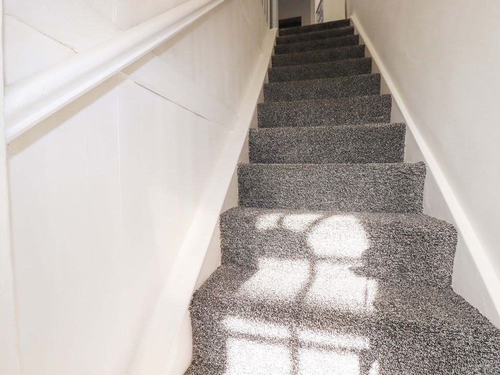 A staircase with carpet and a handrail at 39 Trevarthian road St Austell