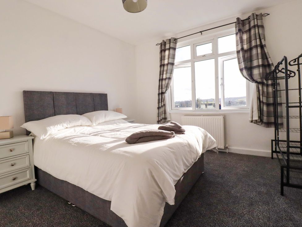 A bedroom with a bed and side table at 39 Trevarthian road St Austell