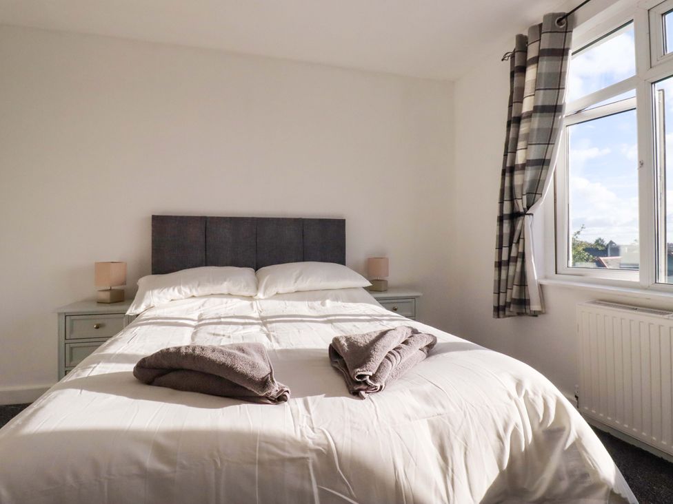 A bedroom with a bed and bedside lamp at 39 Trevarthian road St Austell