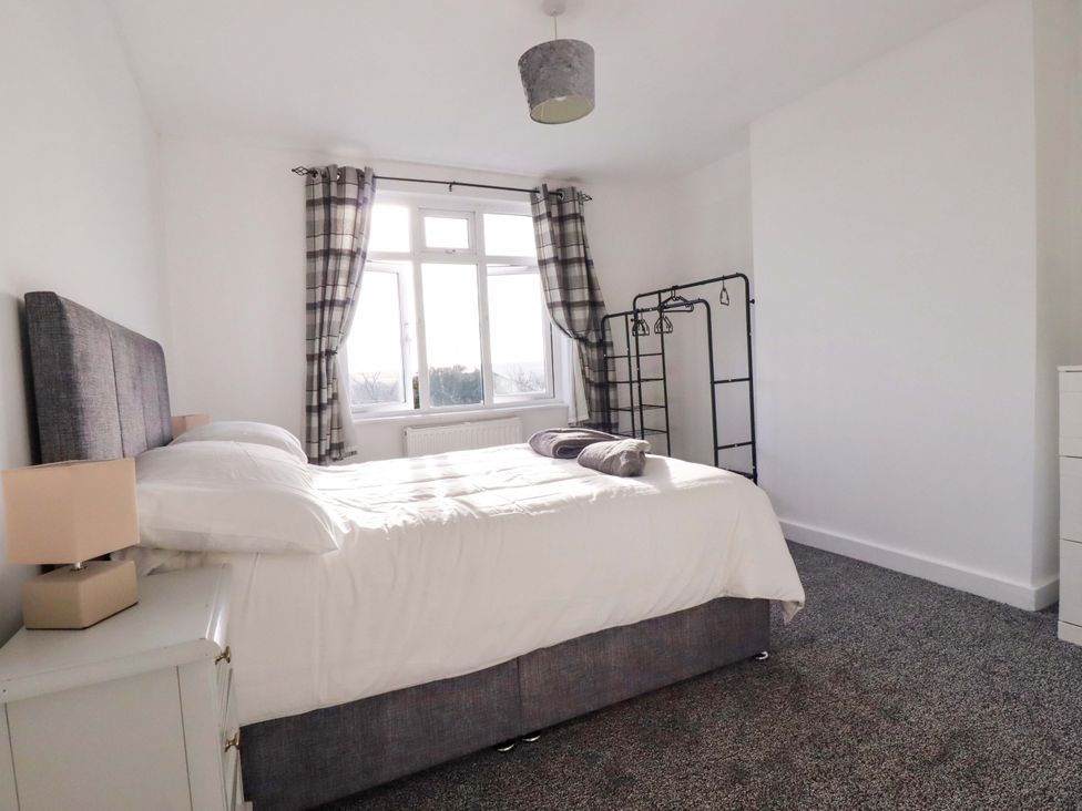A bedroom with a bed and window at 39 Trevarthian road in St Austell