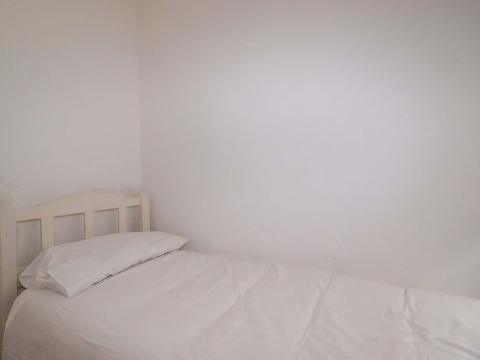 A bed with a pillow in a bedroom at 39 Trevarthian road St Austell