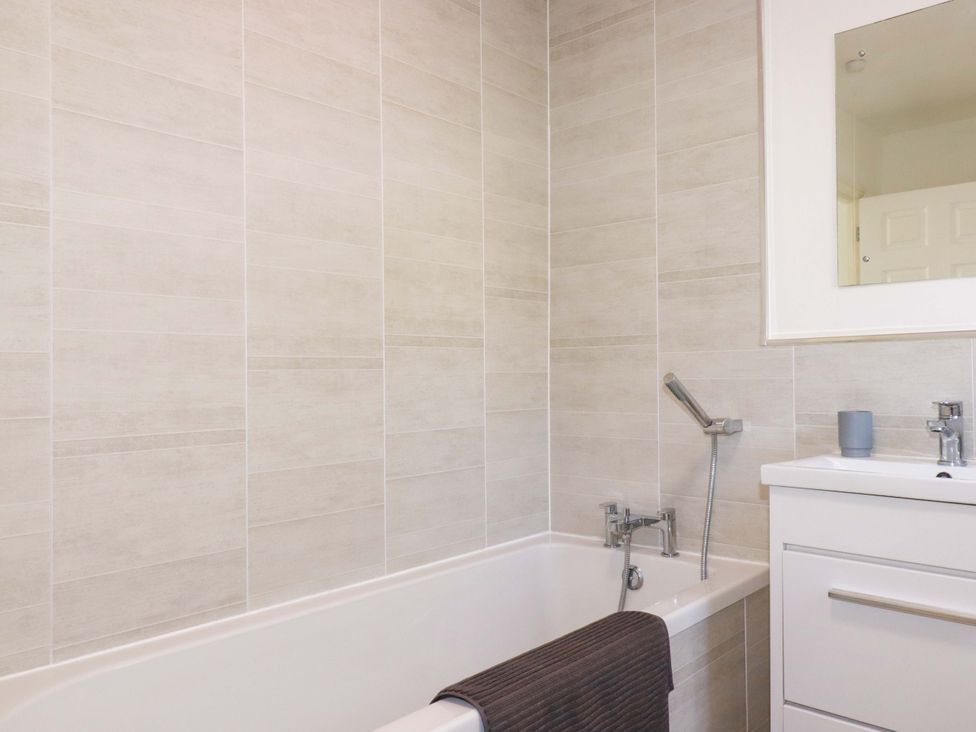A bathroom with a bathtub and sink at 39 Trevarthian road St Austell