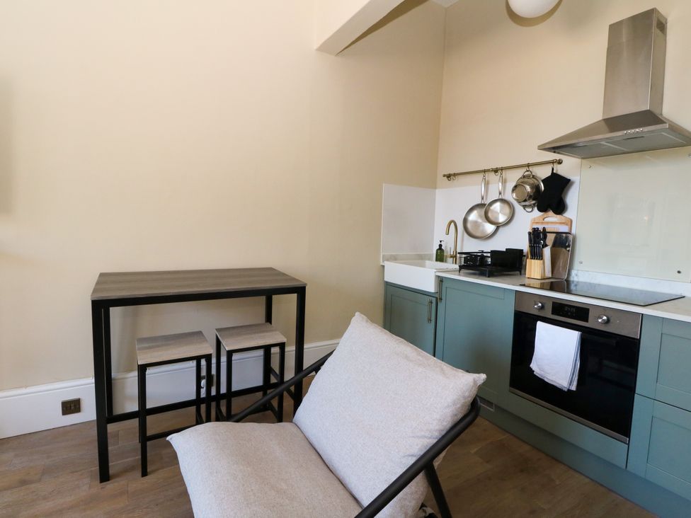 A kitchen with a table and chairs at Flat 1