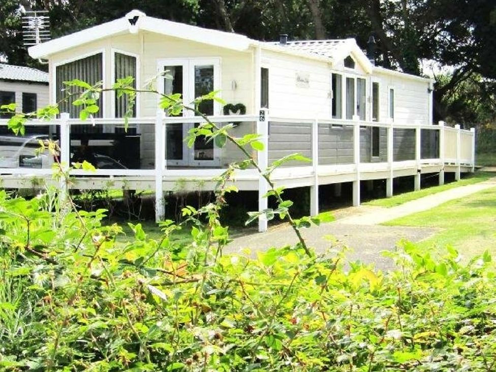 A caravan with decking in an outdoor area at Seton Sands Caravan Park - Holiday Accommodation 13391 Cockenzie And Port Seton