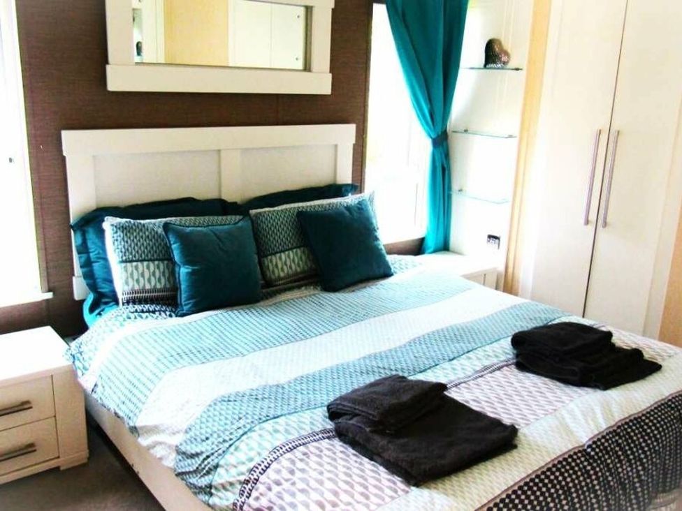 A bedroom with a bed and storage at Seton Sands Caravan Park - Holiday Accommodation 13391 Cockenzie And Port Seton