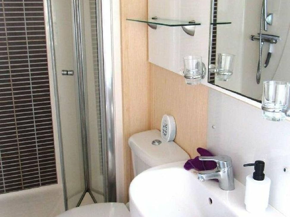 A bathroom with a shower, toilet, and sink at Seton Sands Caravan Park - Holiday Accommodation 13391 Cockenzie And Port Seton