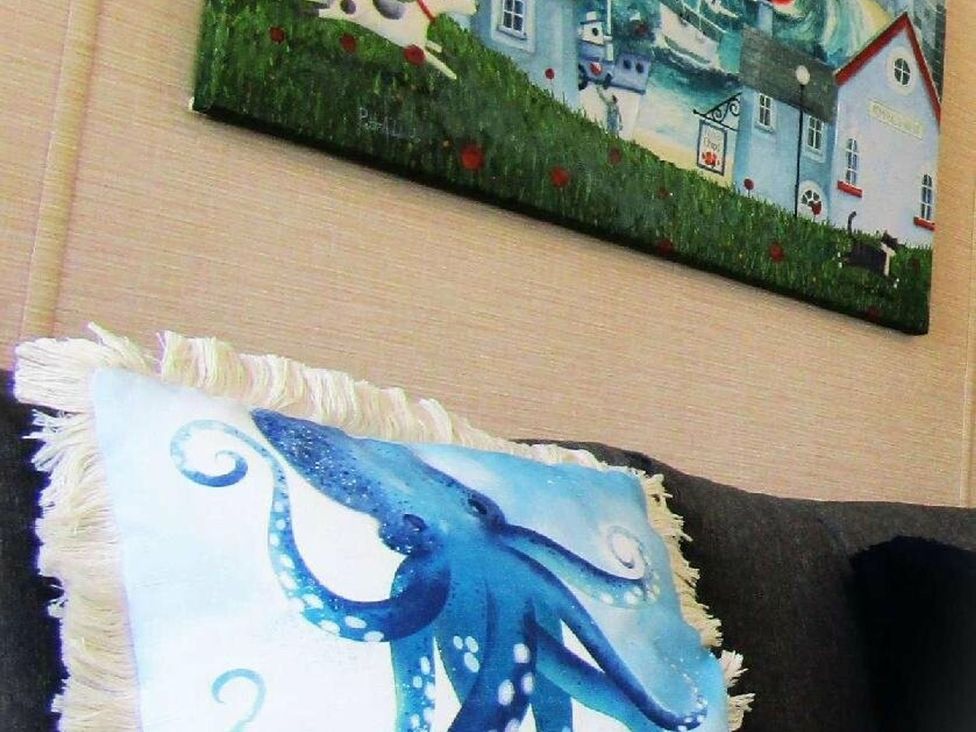 A living room with a painting and a cushion featuring an octopus at Seton Sands Caravan Park - Holiday Accommodation 13391 Cockenzie And Port Seton
