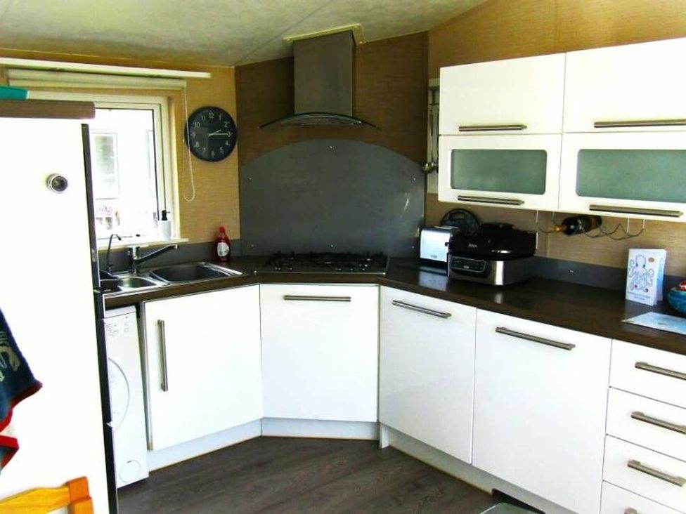 A kitchen with sink and gas stove at Seton Sands Caravan Park - Holiday Accommodation 13391, Cockenzie And Port Seton