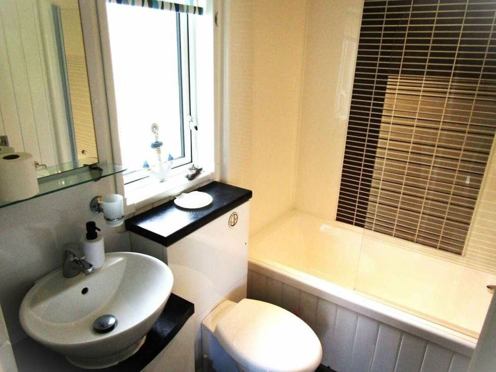 A bathroom with toilet, sink and bathtub at Seton Sands Caravan Park - Holiday Accommodation 13391 Cockenzie And Port Seton