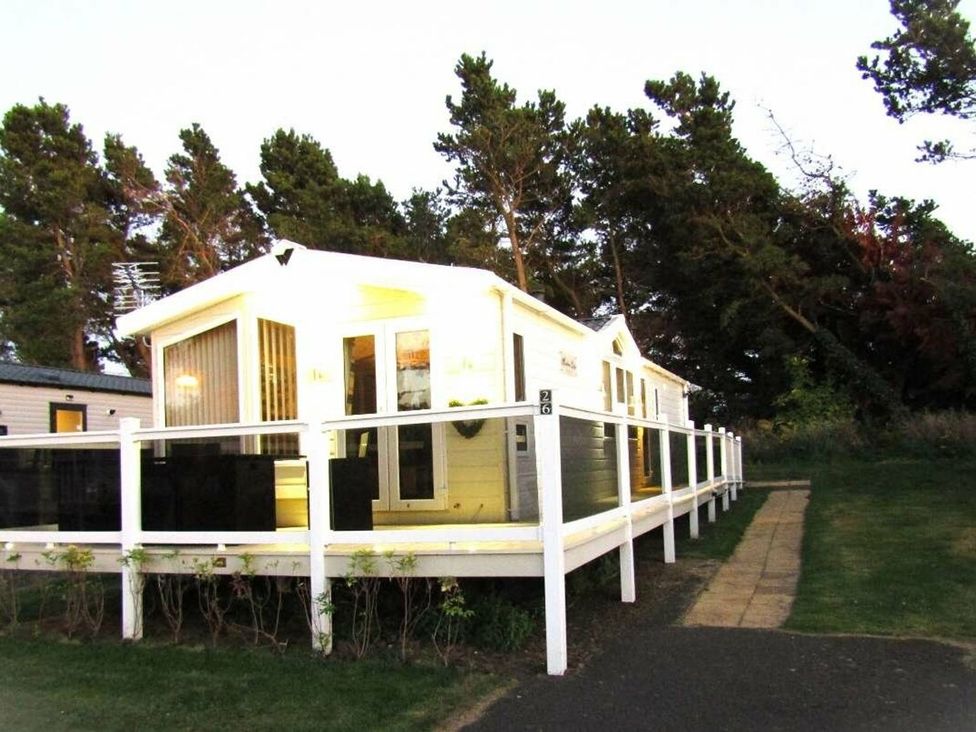 A caravan with a deck and pathway at Seton Sands Caravan Park - Holiday Accommodation 13391 in Cockenzie And Port Seton