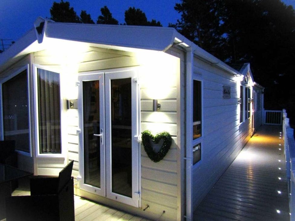 An exterior view of a house with lights on at Seton Sands Caravan Park - Holiday Accommodation 13391 Cockenzie And Port Seton