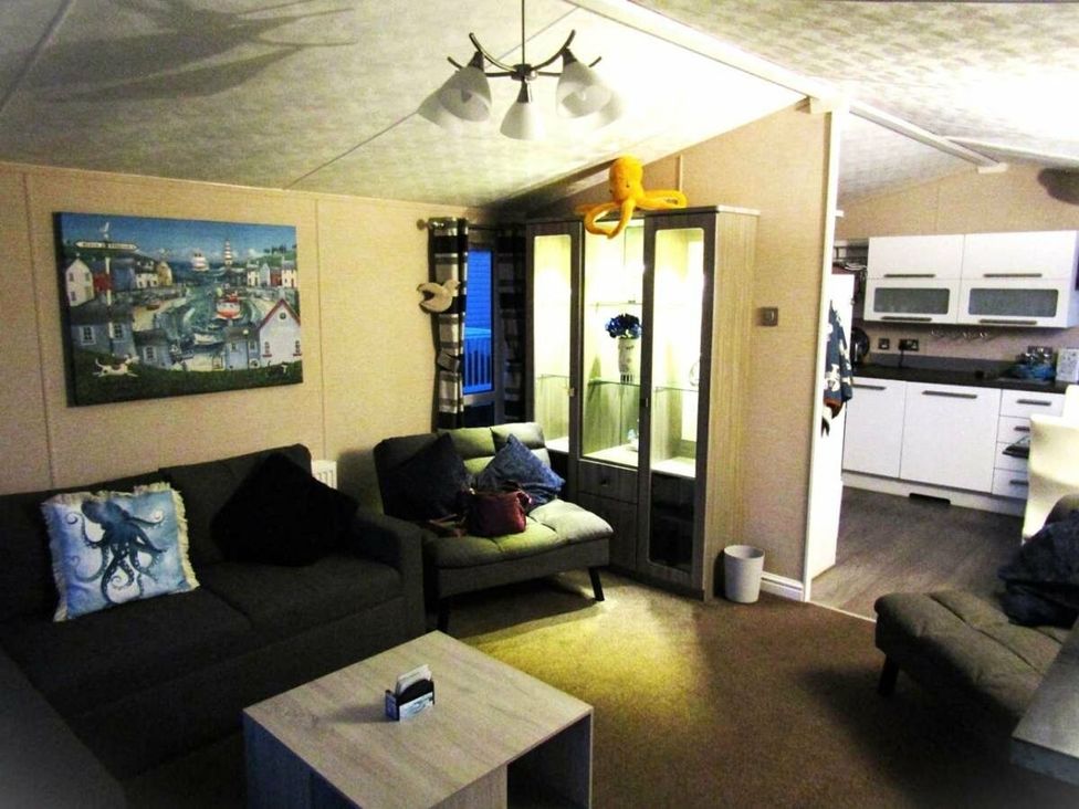A living room with a sofa and coffee table at Seton Sands Caravan Park - Holiday Accommodation 13391, Cockenzie And Port Seton