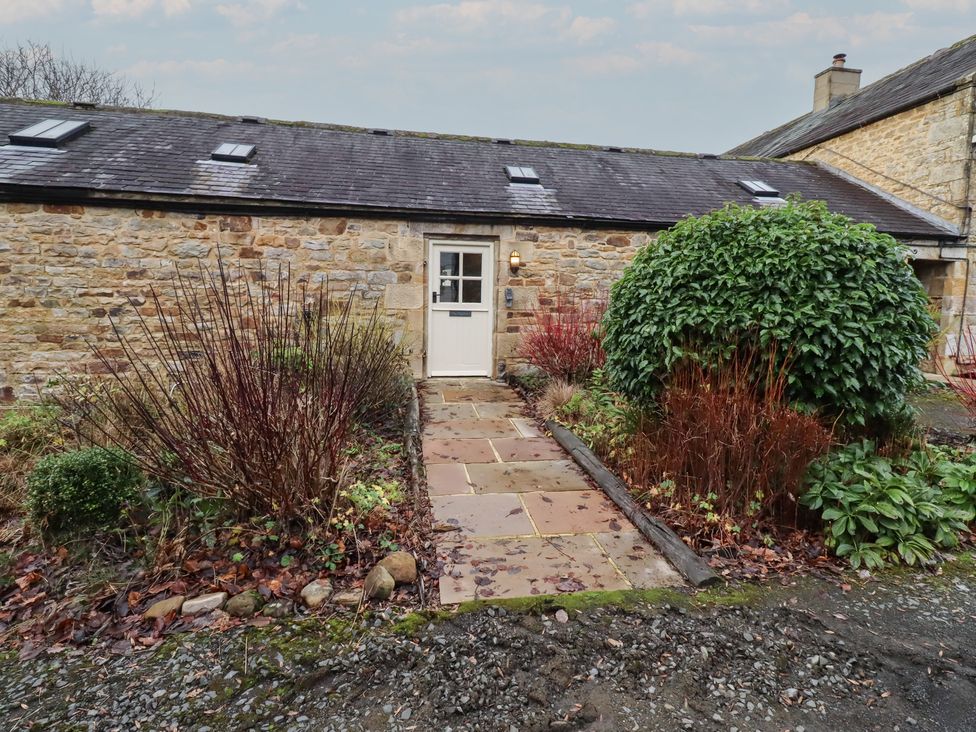 An entrance with a door and pathway surrounded by plants at The Opulent in Hexham