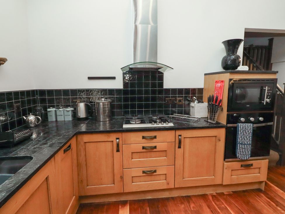 A kitchen with cabinets and appliances at The Opulent in Hexham