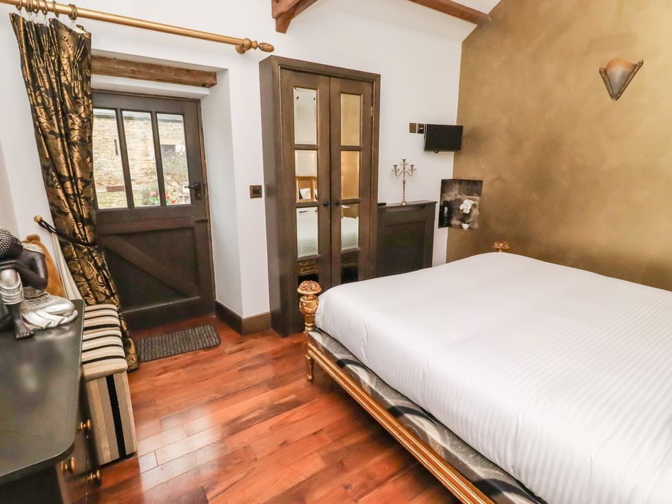 A bedroom with a bed and a door at The Opulent in Hexham