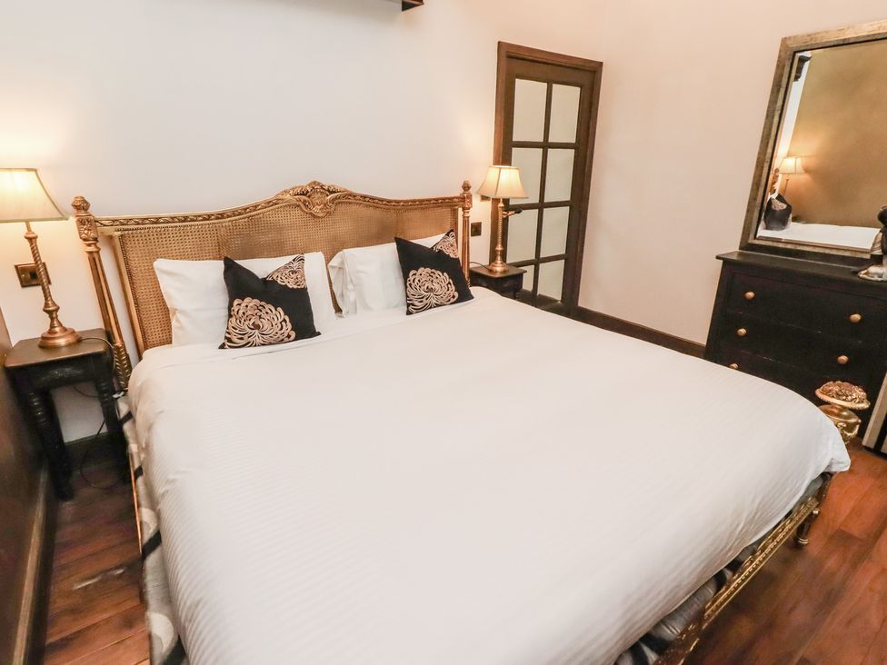 A bedroom with a bed and bedside lamps at The Opulent in Hexham