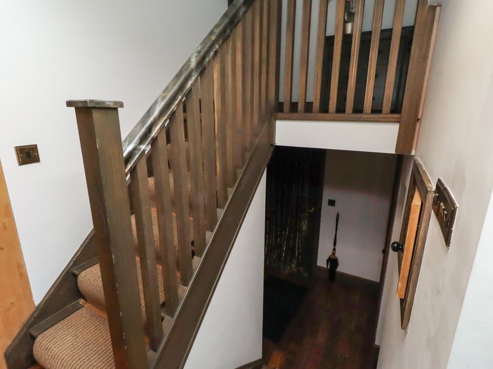 A staircase leading to an upper floor in a hallway at The Opulent in Hexham